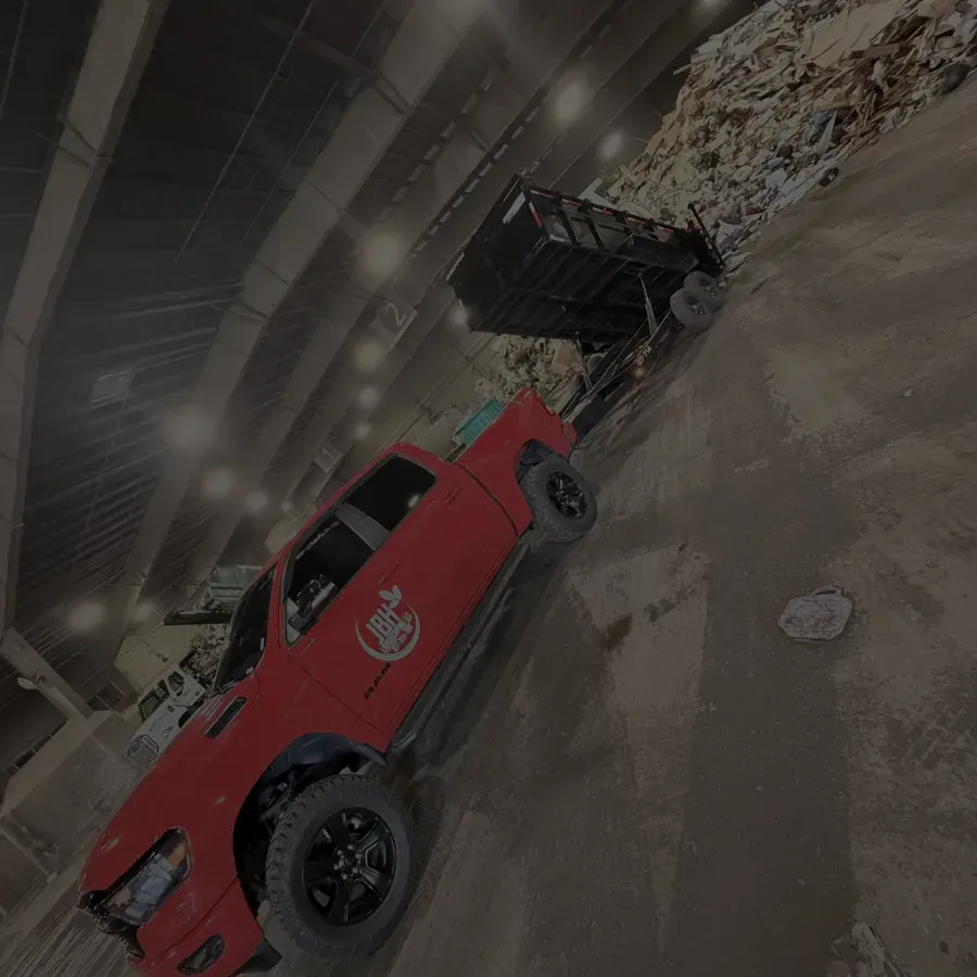 A JBH Landscaping truck and dump trailer unloading at a Dayton-area transfer station
