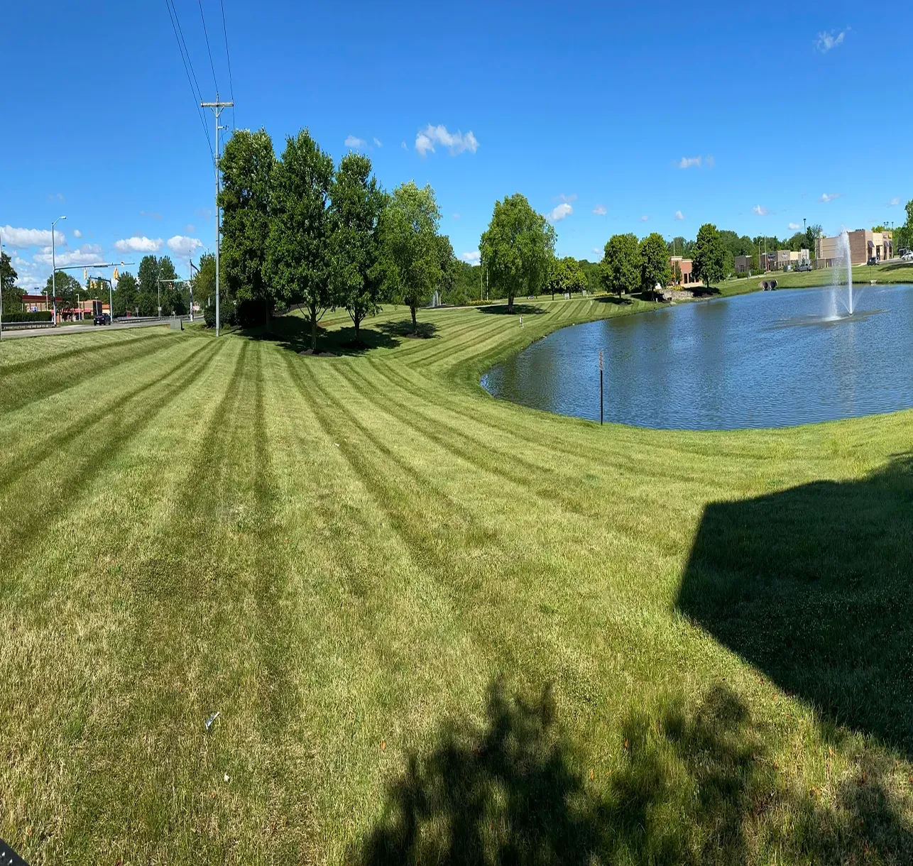 Mowed lawn running down to a pond on a commercial property near Dayton, Ohio