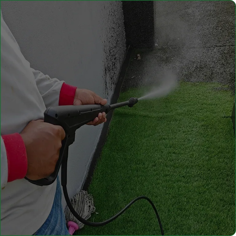 A JBH Landscaping crew member power washing a property in Dayton, Ohio