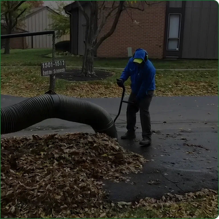 A JBH Landscaping crew member clearing fall leaves in Dayton, Ohio
